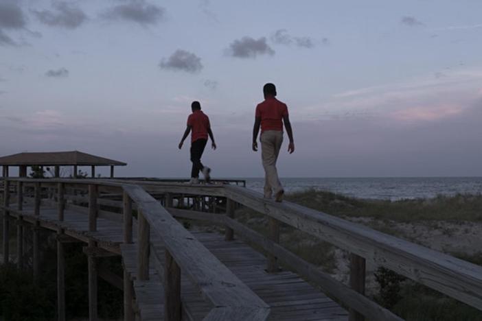 Boys walking on a pier