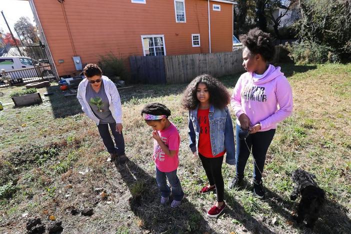 Woman in yard with grandchildren