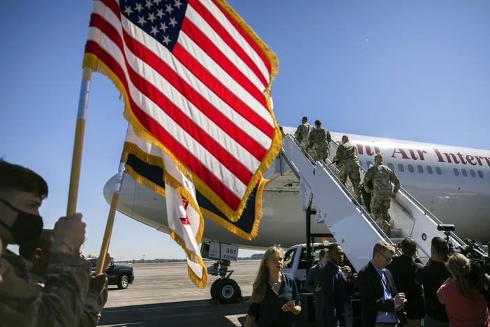 Over 180 soldiers with the U.S. Army 3rd Infantry Division, 1st Armored Brigade Combat Team climb the stairs to a charter airplane at Hunter Army Airfield during their deployment to Germany, Wednesday March 2, 2022 in Savannah, Ga. The division is sending 3,800 troops as reinforcements for various NATO allies in Eastern Europe. 