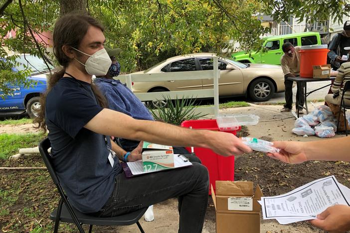 A volunteer with the Atlanta Harm Reduction Coalition gives out sterile syringes in exchange to get potentially contaminated needles off the street.