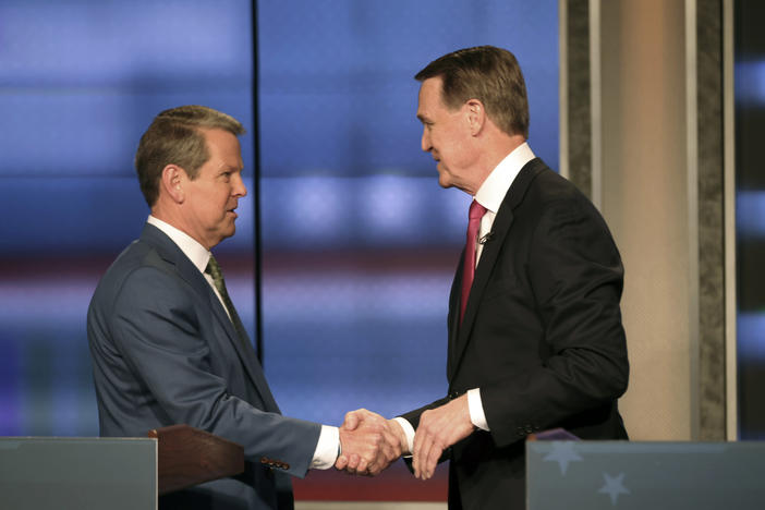 Georgia Gov. Brian Kemp, left, shakes hands with former Sen. David Perdue at a Republican gubernatorial debate, Sunday, April 24, 2022, in Atlanta.