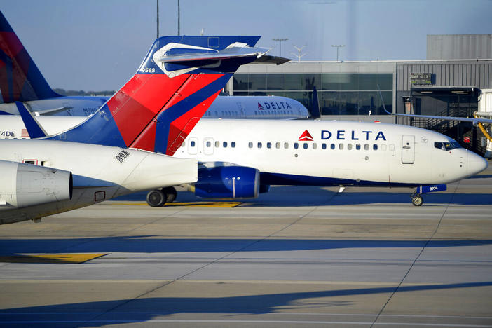 A Delta Airlines aircraft taxi's, Thursday, Dec. 2, 2021, at Hartsfield-Jackson Atlanta International Airport, in Atlanta. Delta Air Lines lost $940 million in the first quarter, Wednesday, April 13, 2022, yet bookings surged in recent weeks, setting up a breakout summer as Americans try to put the pandemic behind them. While Delta's revenue is recovering, the Atlanta airline faces stiff headwinds from higher spending on fuel and labor.