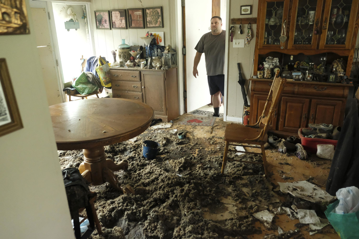 Man surveys insulation on the floor in his dining room