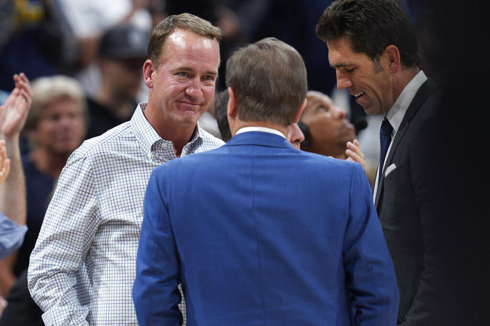 Former NFL quarterback Peyton Manning, left, chats with Joe Lacob, majority owner of the Golden State Warriors, during a timeout in the second half of Game 3 of an NBA basketball first-round Western Conference playoff series between the Warriors and the Denver Nuggets on Thursday, April 21, 2022, in Denver.