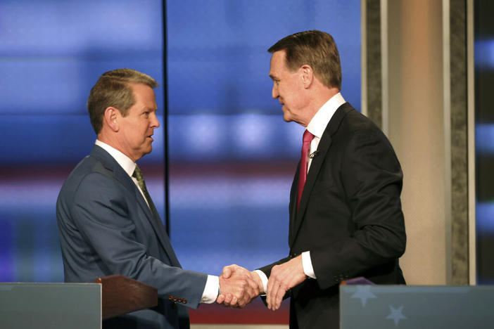 Georgia Gov. Brian Kemp, left, shakes hands with former Sen. David Perdue at a Republican gubernatorial debate, Sunday, April 24, 2022, in Atlanta.