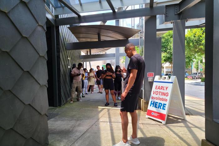 Atlanta voters line up to cast ballots outside an early voting polling place in Buckhead on Friday, May 20, 2022. The early voting period ahead of the May 24 primary saw record turnout in Georgia.