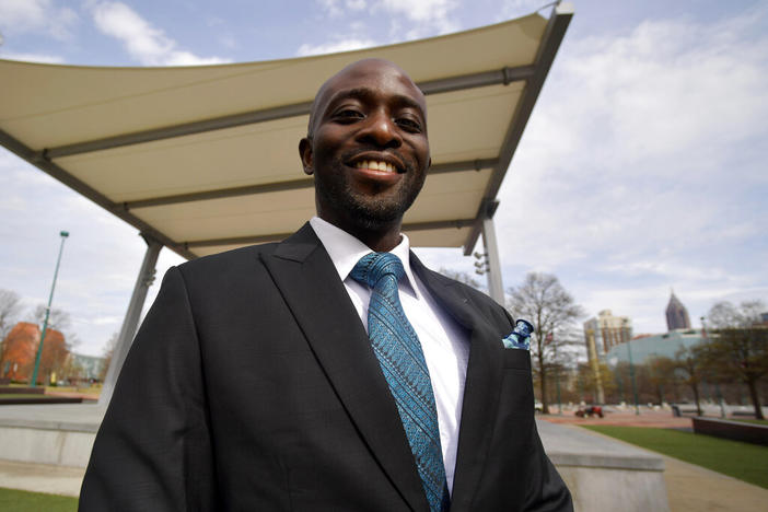 Dr. Dare Adewumi poses for a portrait, Tuesday, March 15, 2022, in Atlanta. Adewumi was thrilled when he was hired to lead the neurosurgery practice at Wellstar Cobb Hospital in Austell, Ga., in the Atlanta-area near where he grew up. But he says he quickly faced racial discrimination that ultimately led to his firing and has prevented him from getting permanent work elsewhere. His lawyers and other advocates say he's not alone. 