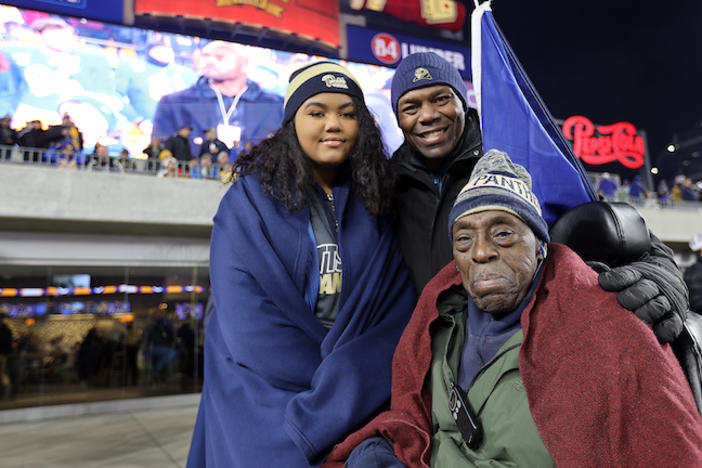 A girl with her father and grandfather.