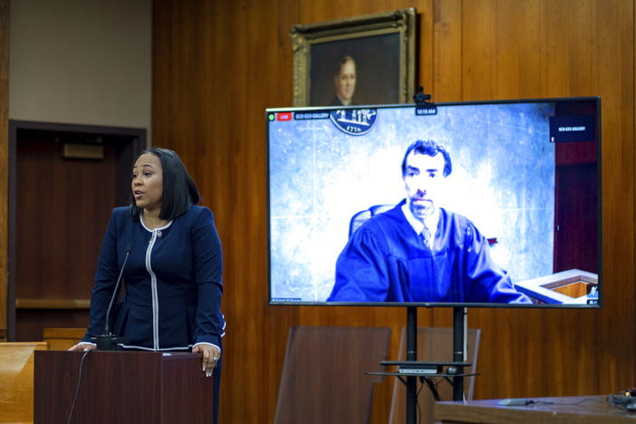 Fulton County District Attorney Fani Willis addresses potential jurors as Fulton County Superior Court Judge Robert McBurney is seen on a video screen during proceedings to seat a special purpose grand jury in Fulton County, Georgia, on Monday, May 2, 2022, to look into the actions of former President Donald Trump and his supporters who tried to overturn the results of the 2020 election. The hearing took place in Atlanta.