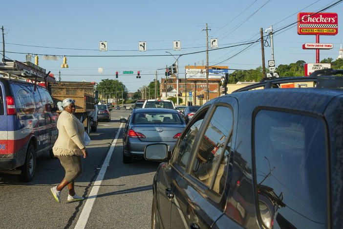 Mika Shills crosses Spring Street in Macon with the red light going her way by about 20 yards from the crosswalk a few hours after another pedestrian was hit and killed near the same spot. Shills is careful about crossing Macon roadways on foot but says nowhere is really safe to do it. "They'll speed up and try to hit you out here," she said.