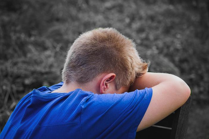 Unidentified child with their head down