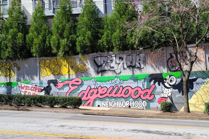 A wall mural is painted with the words 'welcome to edgewood' as you walk into the neighborhood.