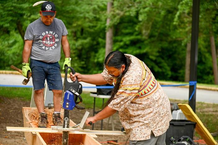 Men building canoe