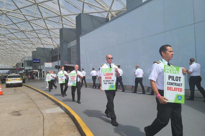 Delta Air Lines pilots demonstrate outside Hartsfield-Jackson Atlanta International Airport on June 30, 2022, demanding better working conditions.