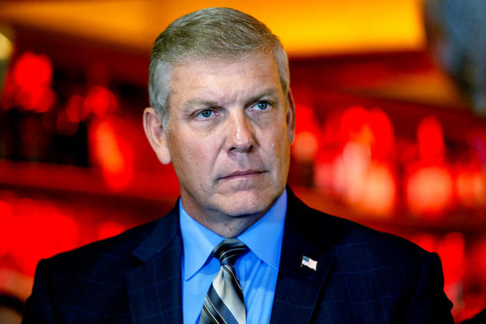 Rep. Barry Loudermilk, R-Georgia, listens to a speaker at a press conference, May 4, 2021, in Marietta, Ga. Police have determined a House Republican who led a tour of the U.S. Capitol the day before the Jan. 6 attack was simply showing his constituents around and not suspicious. The tour by Loudermilk had drawn scrutiny from the congressional panel investigating the insurrection.