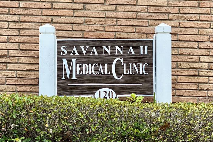 Brick exterior of the Savannah Medical Clinic. A sign for the clinic is displayed in front of the building, behind bushes.