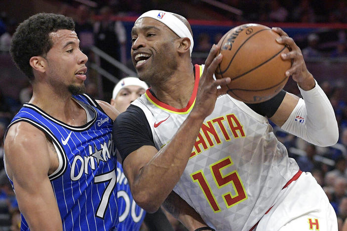 Atlanta Hawks forward Vince Carter (15) drives to the basket against Orlando Magic guard Michael Carter-Williams (7) during the first half of an NBA basketball game in Orlando, Fla., Friday, April 5, 2019. Police say nearly $100,000 in cash was taken in a weekend burglary at the Atlanta home of former NBA player Vince Carter. Police said in an incident report released Wednesday, June 22, 2022 that two guns and more than $16,000 was recovered outside the home after Sunday's burglary.
