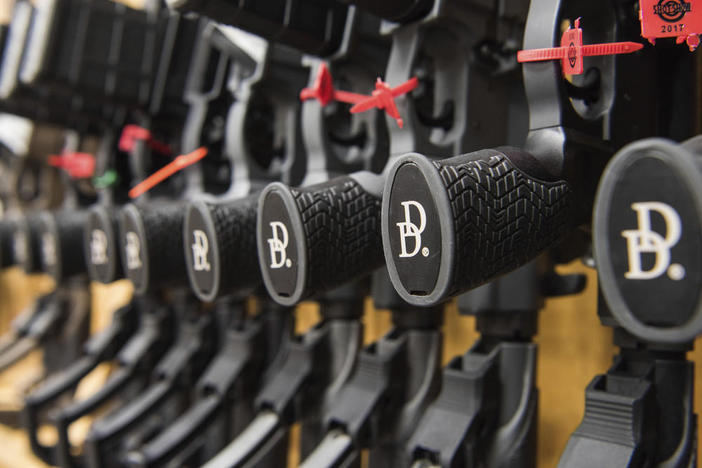 In this March 9, 2017, photo a row of AR-15 style rifles manufactured by Daniel Defense sit in a vault at the company's headquarters in Black Creek, Ga.