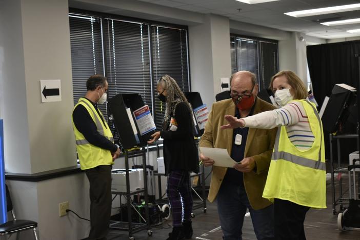 In Georgia, the Legislature gave the Georgia Bureau of Investigation authority to investigate election crimes and issue relevant subpoenas. Cobb County poll workers helped voters cast ballots in 2020.