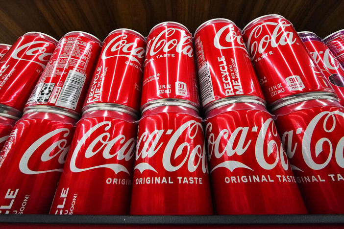 Cans of Coca-Cola are on display at a grocery market in Uniontown, Pa, on Sunday, April 24, 2022. Coca-Cola posted higher-than-expected sales in the second quarter, Tuesday, July 26, due to price increases and continuing improvement in demand at restaurants and other venues. The Atlanta-based company said revenue grew 12% in the April-June period to $11.3 billion.