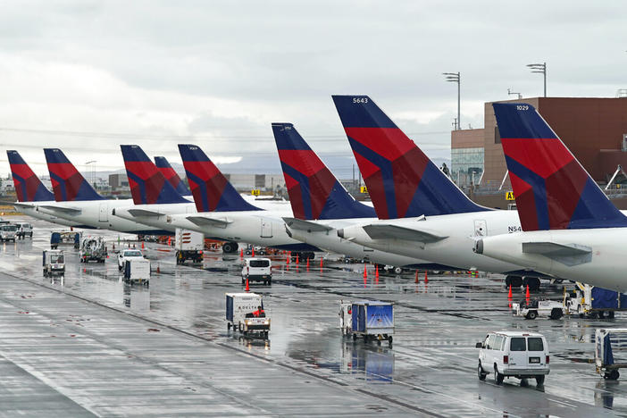 Delta planes sit at their gates on June 13, 2022, at Salt Lake City International Airport, in Salt Lake City. Delta Air Lines has agreed to pay $10.5 million to settle charges it falsified information about deliveries of international mail, including mail sent to U.S. soldiers overseas. The Justice Department said Thursday, June 30, 2022, that Delta was under contract to the Postal Service when it falsified records about deliveries from 2010 to 2016. 