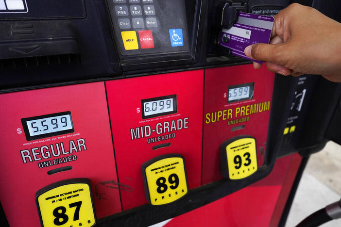A customer holds a credit card at the pay-at-the-pump gasoline pump in Rolling Meadow, Ill., Thursday, June 30, 2022. U.S consumers have so far defied higher prices for gas, food, and rent and have been spending more in 2022, providing crucial support to the economy. The Wall Street Journal reports that Visa and Mastercard have raised the amount a gas station can hold up to $175 on credit or debit card at the pump. 
