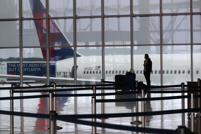 A Delta Air Lines plane sits at the International Terminal at Hartsfield-Jackson International Airport with a solitary international traveler trying to get a flight home amid European travel restrictions Monday, March 16, 2020, in Atlanta. International and domestic air travel has been hammered by the coronavirus. Curtis Compton ccompton@ajc.com