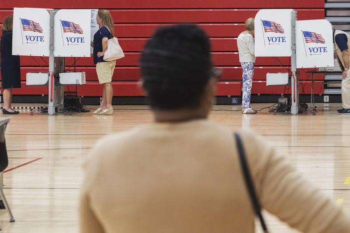 The first voters under Georgia's newly passed voting rules in the East Macon 3 precinct in Macon, Ga., cast their ballots on Tuesday.⁠