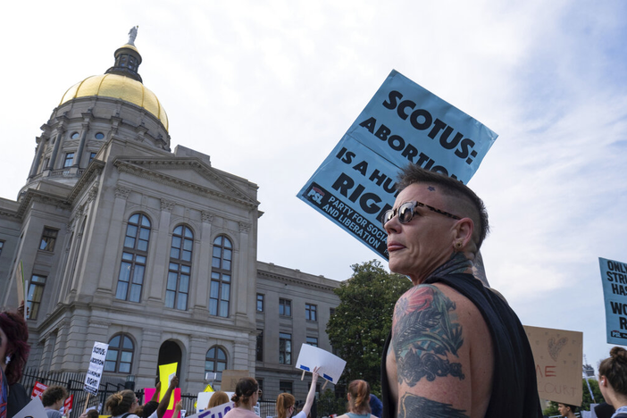 People gather in front of the Georgia State Capital in Atlanta on Friday, June 24, 2022, to protest the Supreme Court decision striking down Roe v. Wade.