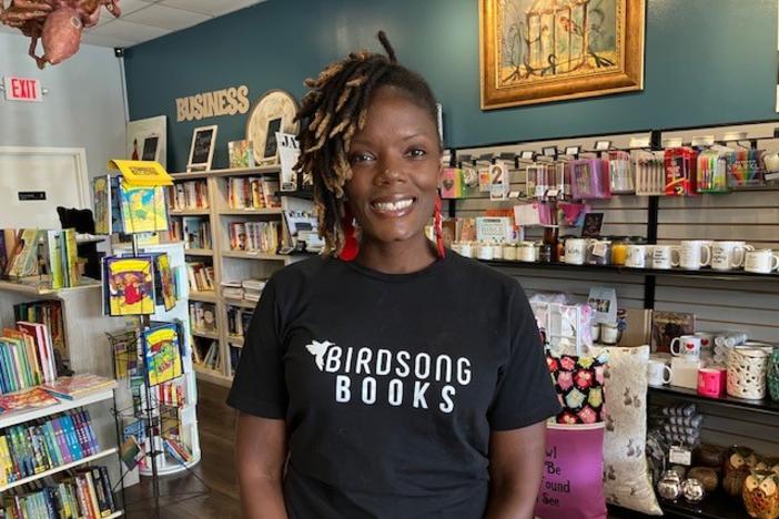 Erica Atkins is pictured in front of books at gifts at her bookstore in Locust Grove, Ga.