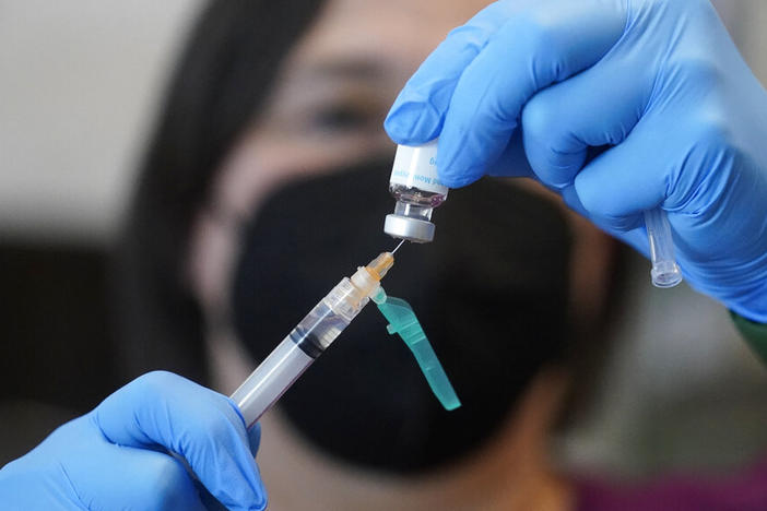 A registered nurse prepares a dose of a Monkeypox vaccine at the Salt Lake County Health Department Thursday, July 28, 2022, in Salt Lake City. U.S. health officials on Tuesday, Aug. 9, 2022, authorized a new monkeypox vaccination strategy designed to stretch limited supplies by allowing health professionals to vaccinate up to five people — instead of one — with each vial.