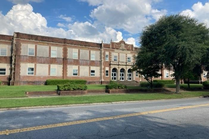 A 1925 school building is shown.