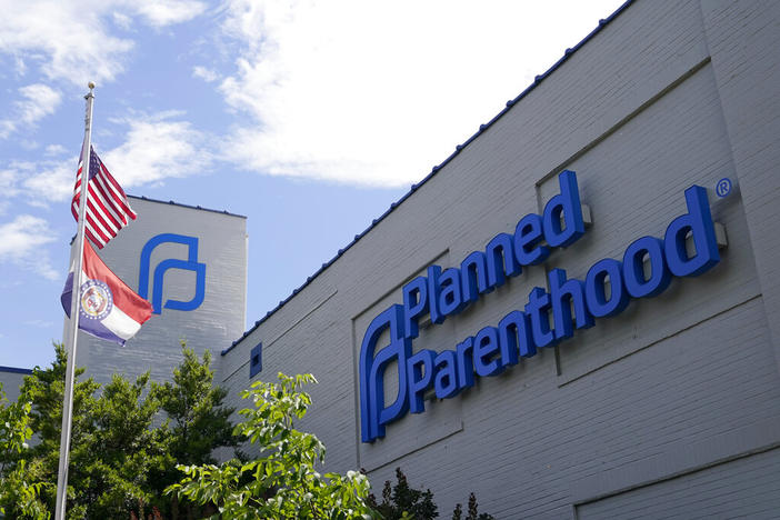 Missouri and American flags fly outside Planned Parenthood June 24, 2022, in St. Louis. Planned Parenthood, the nation's leading reproductive health care provider and abortion rights advocacy organization, plans to spend a record $50 million ahead of November's midterm elections, pouring money into contests where access to abortion will be on the ballot.