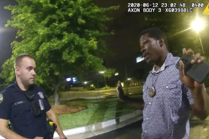 In this June 12, 2020, file photo from a screen grab taken from body camera video provided by the Atlanta Police Department Rayshard Brooks, right, speaks with Officer Garrett Rolfe, left, in the parking lot of a Wendy's restaurant, in Atlanta. 