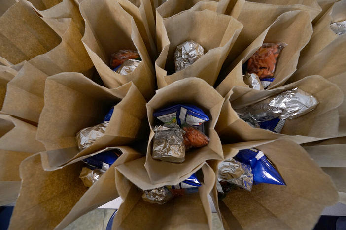 Bagged lunches await stapling before being distributed to students at Jefferson county's Tri-Plex Campus involving the students from the Jefferson County Elementary School, the Jefferson County Upper Elementary School and the Jefferson County Junior High School, March 3, 2021 in Fayette, Miss. 