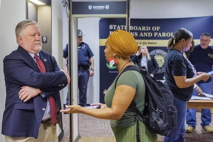 Andrea Guice, right, talks to Georgia Board of Pardons and Parole spokesperson Steve Hayes after the board's September meeting. Guice's brother has served 8 years in prison after his first possible parole date. "Who do we need to talk to and how can we, you know, get together with the system to make it better for him?” Guice asked.  