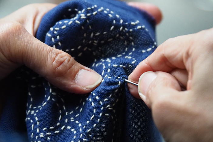 close up shot of hands sewing