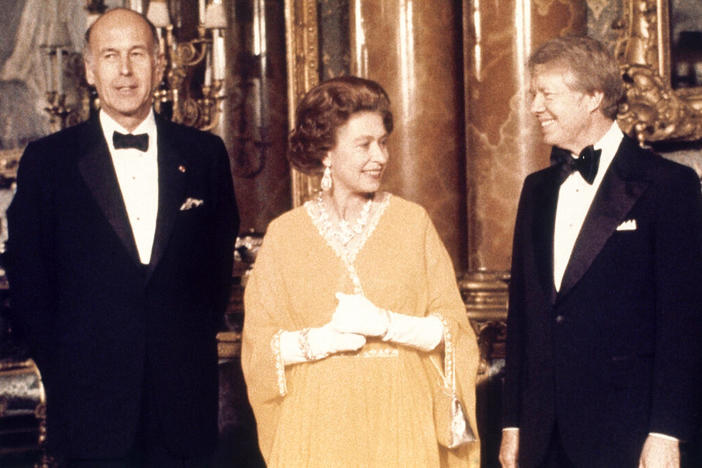  In this file photo dated May 1977, U.S. President Jimmy Carter, right, and Britain's Queen Elizabeth II are photographed with French President Valery Giscard d'Estaing, at Buckingham Palace in London. Queen Elizabeth II, Britain’s longest-reigning monarch and a rock of stability across much of a turbulent century, has died. She was 96. Buckingham Palace made the announcement in a statement on Thursday Sept. 8, 2022.