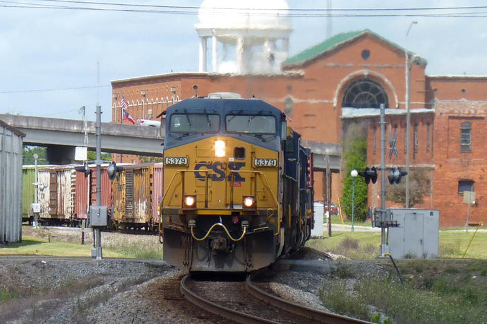 A freight train bearing the logo of CSX Transportation travels through Valdosta, Georgia.