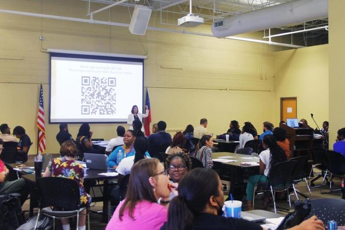 Holly Huynh, talent management coordinator for Bibb Schools, welcomes new teachers at the first monthly professional learning night of the school year Sept. 8, 2022. About 170 teachers attended and all were recent career changers.