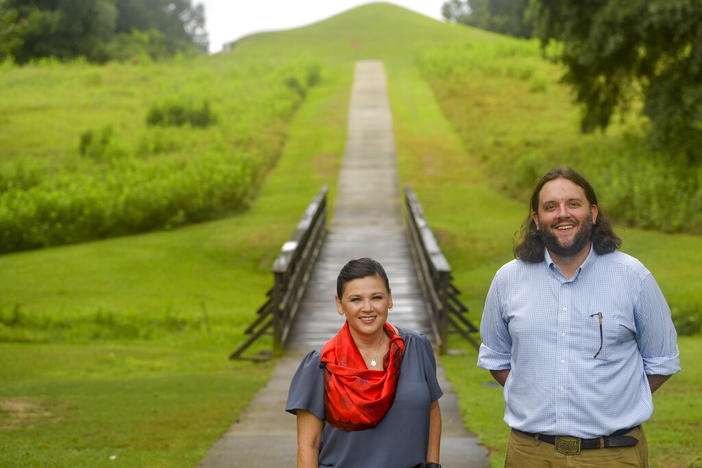 Tracie Revis, left, a citizen of the Muscogee Creek Nation, and Seth Clark, mayor pro-tem of Macon, stand at the approach to the Earth Lodge, where Native Americans held council meetings for 1,000 years until their forced removal in the 1820s, on Aug. 22, 2022, in Macon, Ga. Revis and Clark are co-directors of an initiative to bring 50 miles of the Ocmulgee River under federal protection as a national park.
