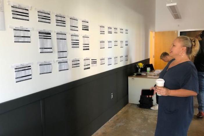 Rebekah Weigel of Peacetree Productions scans the shooting schedule Wednesday in their temporary Macon office at 338 Poplar St. (Liz Fabian)