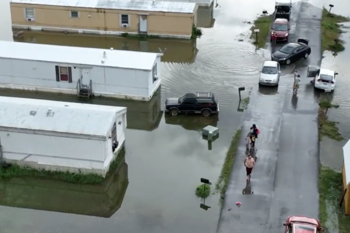 Mobiles homes are shown with water encroaching.