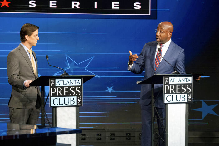 Libertarian challenger Chase Oliver, left, and Sen. Raphael Warnock, D-Ga., participate in a U.S. Senate debate during the Atlanta Press Club Loudermilk-Young Debate Series in Atlanta on Sunday, Oct. 16, 2022. Republican challenger Herschel Walker was invited but did not attend. (AP Photo/Ben Gray)