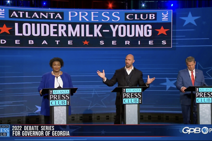 Libertarian candidate Shane Hazel (center) interrupts the moderators,  Democrat Stacey Abrams and Gov. Brian Kemp in an Atlanta Press Club debate Monday, Oct. 17, 2022.