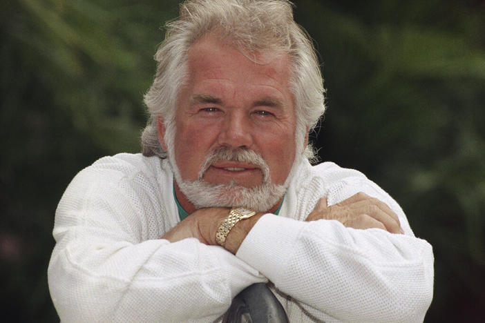 FILE - This May 17, 1989 file photo shows Kenny Rogers posing for a portrait in Los Angeles. Rogers, who embodied “The Gambler” persona and whose musical career spanned jazz, folk, country and pop, has died at 81. A representative says Rogers died at home in Georgia on Friday, March 20, 2020. (AP Photo/Bob Galbraith, File)