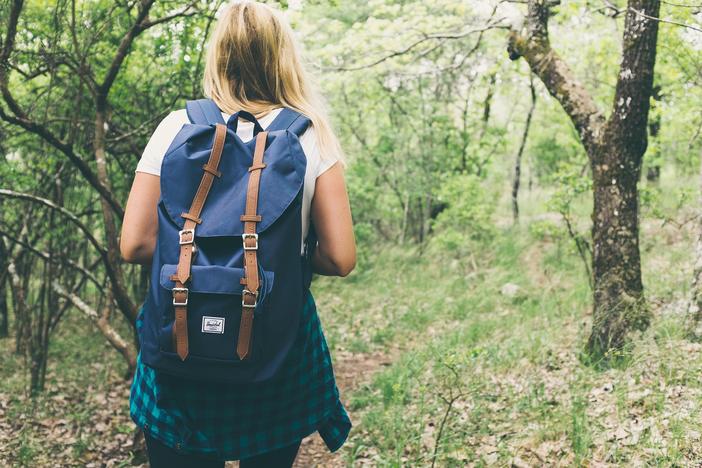woman backpacking in woods