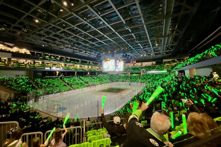 Fans of the Savannah Ghost Pirates cheer during a pregame ceremony at Enmarket Arena, shortly before the team took to the ice for their inaugural home game.