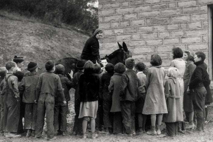 A librarian on horseback in a black and white picture.