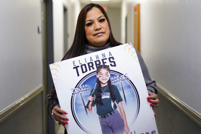 Sandra Torres, holds a photo of her daughter Eliahna, who was one of 19 students and two teachers killed in the school shooting in Uvalde, Texas, at her attorney's office, Monday, Nov. 28, 2022, in San Antonio, where she filed a federal lawsuit against the school district, police, city and the maker of the gun used in the slaying.